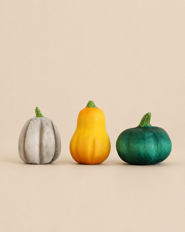 Bumbu Handmade Wooden Pumpkin Patch Set featuring three decorative pumpkins in grey, yellow, and green, each with a small green stem.