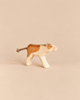 Ostheimer Calf - Drinking: a handcrafted wooden toy calf with brown patches and a rope tail, shown in a standing, lowered-head position.