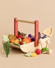 A Wild Wood Foraging Trug, which is a wooden toy basket filled with pretend play fruits, vegetables, and edible toy mushrooms, with a small wooden trowel resting inside.