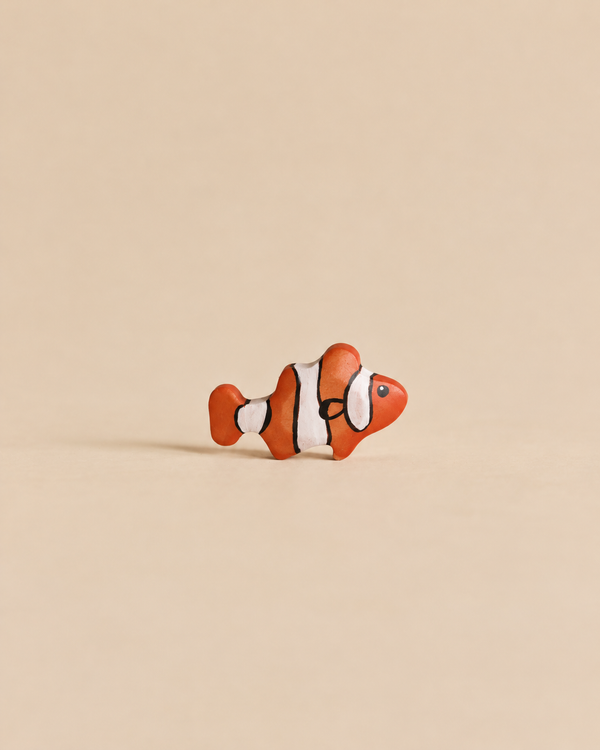 Small handmade Holzwald Clownfish figurine with orange, white, and black stripes.