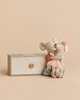 Two small Maileg Big Sister and Me Set mouse dolls hugging each other next to a striped box.