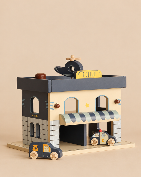 Konges Sloejd Wooden Police Station with a helicopter on the roof and two wooden toy cars in front.