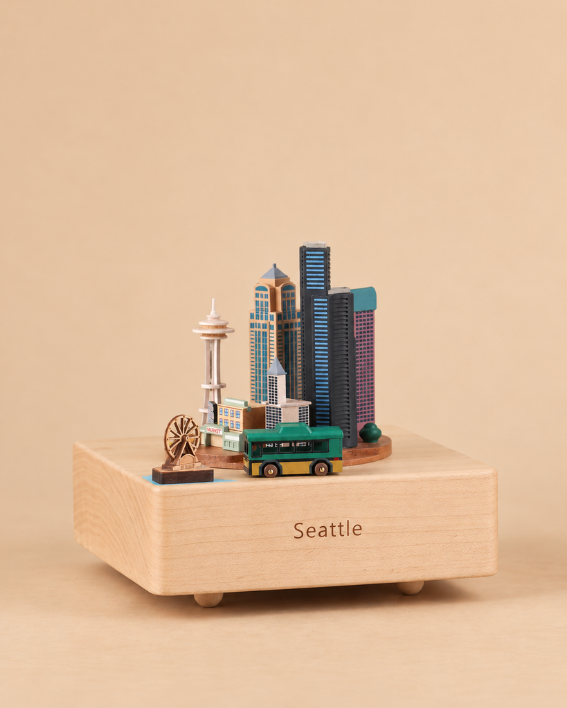 Seattle Wooden Music Box featuring a miniature Seattle skyline with the Space Needle, a Ferris wheel, and a green bus, with “Seattle” engraved on the front base.
