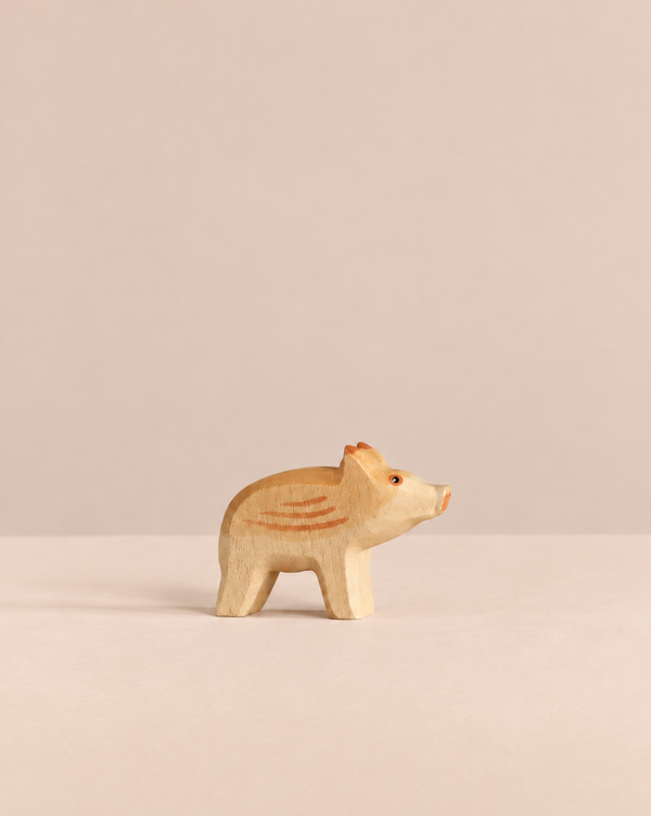 Handmade Holzwald Small Wild Boar - Head Up wooden toy figurine of a wild boar piglet standing with its head turned to the side.