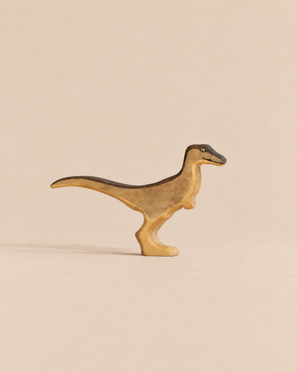 Handmade Holzwald Dinosaur - Velociraptor toy in shades of tan and dark brown, perfect for sustainable imaginative play.