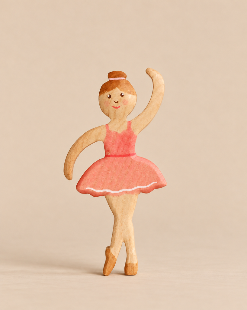 A Handmade Holzwald Ballerina wooden figurine wearing a painted pink leotard and tutu, perfect for imaginative play.