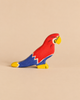 Holztiger Parrot, a handcrafted wooden toy painted in red, blue, and yellow.