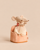 A Maileg Big Sister and Me Set featuring a large mouse in a red and white striped shirt hugging a smaller mouse in a lacy cream-colored dress, both sitting together in a small, upholstered pink armchair.