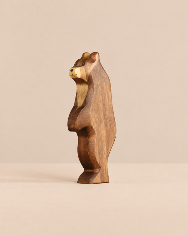 A Handmade Holzwald Bear - Standing, a carved wooden figurine of a bear in profile designed for imaginative play.