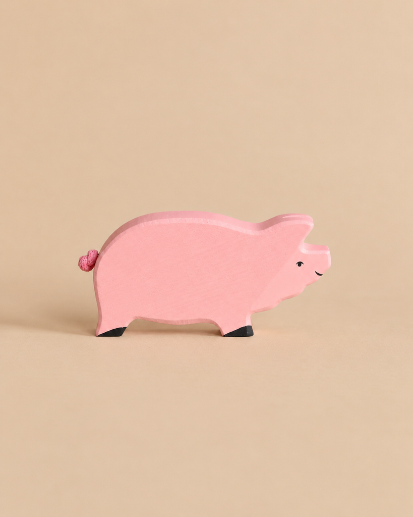 Holztiger Pig handcrafted wooden toy, painted pink with small black hooves.