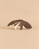 Holztiger Anteater handcrafted wooden toy with dark brown fur and a white stripe along its side.