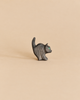 Small black Ostheimer Cat For Witch wooden figurine with a raised tail and a single green eye.