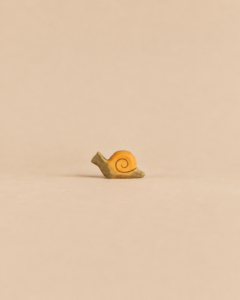 A small Handmade Holzwald Snail, Small with a tan body and a yellow spiral shell.