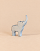 An Ostheimer Small Elephant - Trumpeting, a handcrafted wooden toy with its trunk raised, perfect for imaginative play.