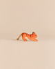 Ostheimer Tiger Lurking, Small, a handcrafted wooden tiger figurine in a pouncing pose with a rope tail.