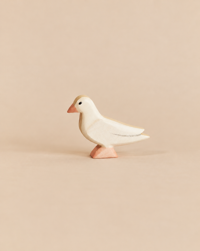 Handmade Holzwald Bird - Dove in profile, a small wooden toy with a pale body, orange beak, and orange feet.