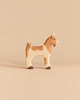 Handcrafted wooden Holztiger Goat toy figure with white and brown patches.