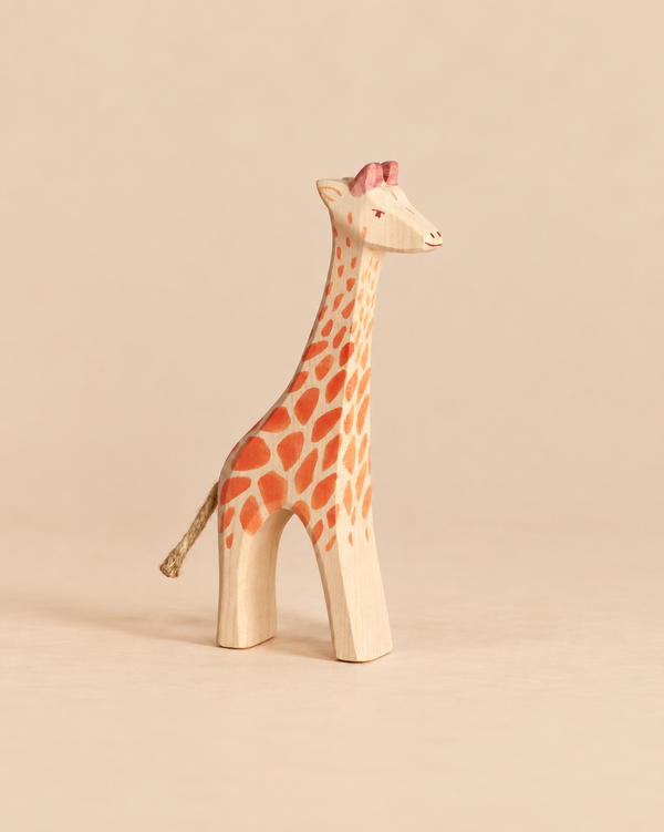 Ostheimer Giraffe - Standing, a hand-carved wooden figurine with orange spots, a rope tail, and the classic charm of handcrafted wooden toys.