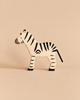 Hand-painted Holztiger Zebra wooden toy in profile.