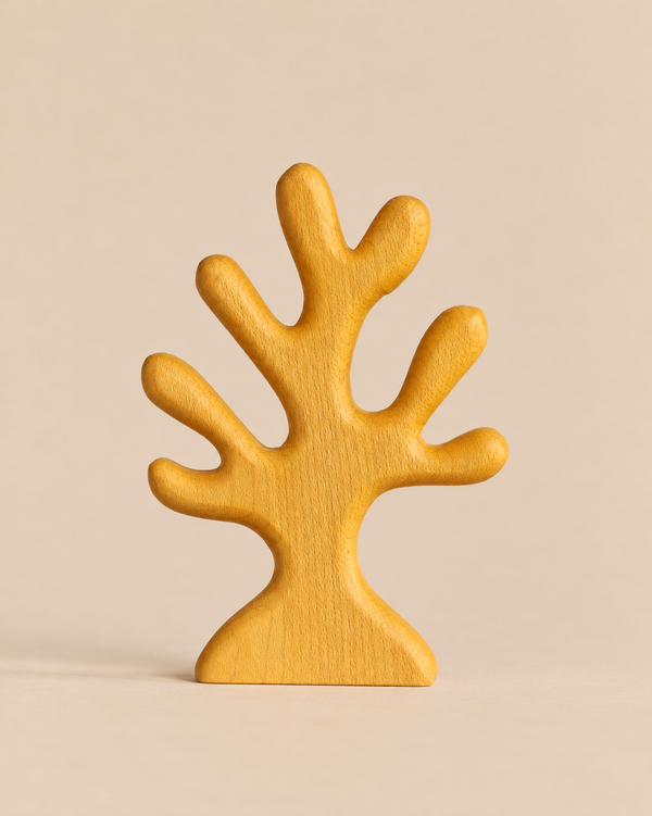 A yellow wooden Handmade Holzwald Yellow Coral toy shaped like a stylized tree.