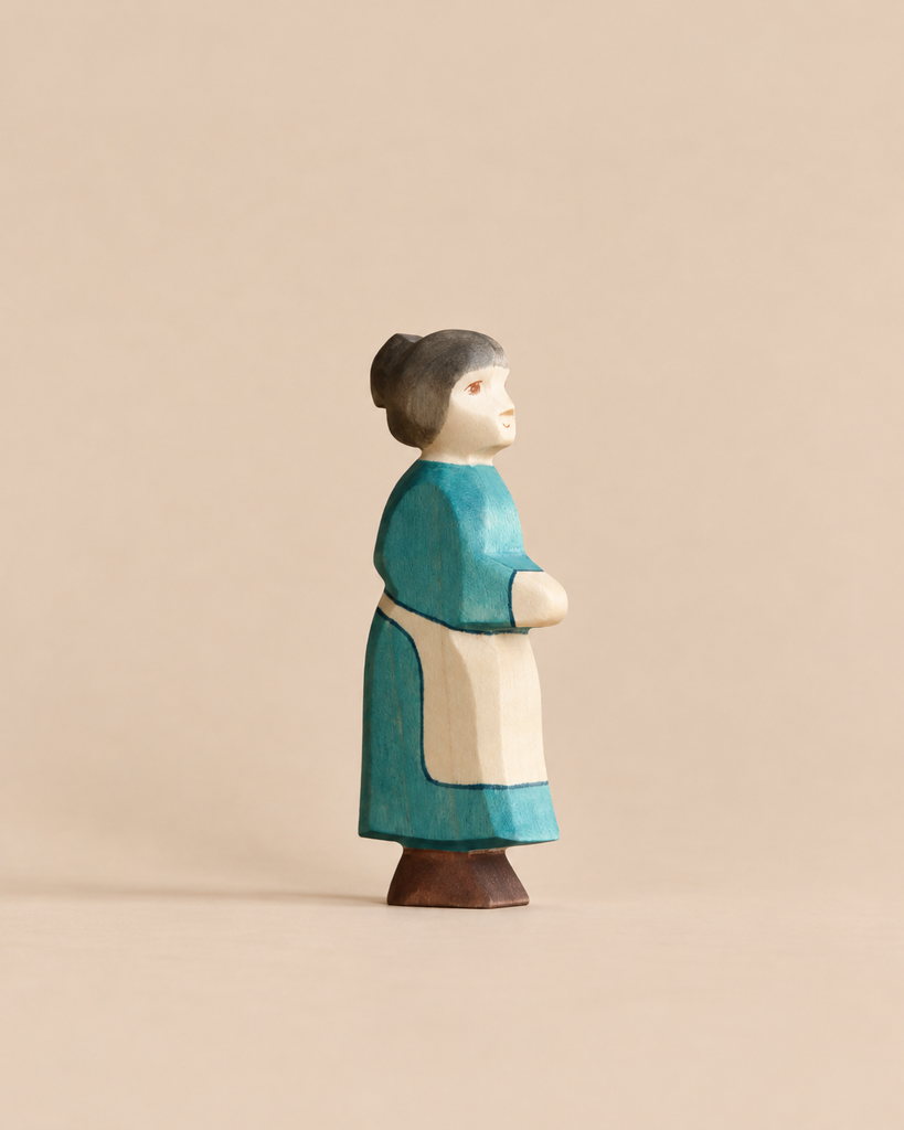 Handmade Holzwald Grandmother figurine, hand-carved from wood and wearing a blue dress with a cream apron.