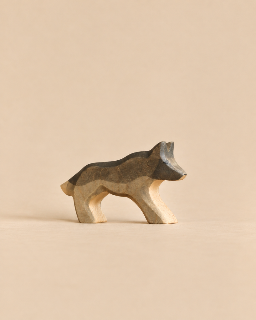 A handmade Holzwald Wolf figurine featuring a grey and brown stained back.
