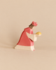 Ostheimer Red King With Crown: a handcrafted wooden toy figure of a king in a red robe and crown, kneeling and holding a yellow orb for imaginative play.