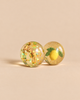 Konges Sloejd Glitter Bouncing Ball Set - Lemon & Tiger featuring two clear bouncy balls with glitter: one containing a tiger and star-shaped confetti, and the other containing a lemon with leaves.