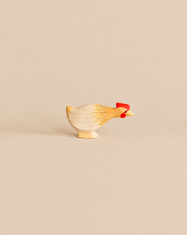 Ostheimer Long Neck Hen - Ochre, a handcrafted wooden hen figurine featuring an ochre-painted neck and a bright red comb.