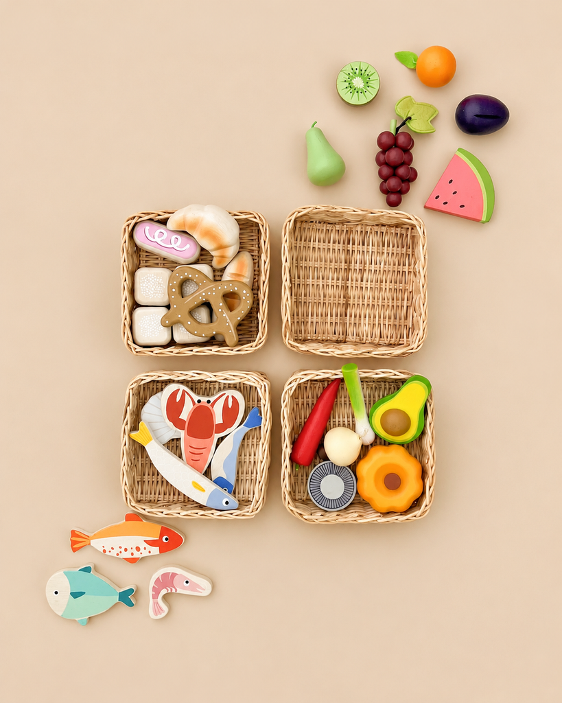 Four Market Basket sets filled with wooden pretend play toys, including bakery items, a lobster, fish, and various fruits and vegetables, arranged on a light background.