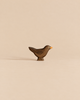 Handmade Holzwald Bird - Blackbird, a small, dark wooden bird figurine with a yellow beak crafted as a sustainable toy.