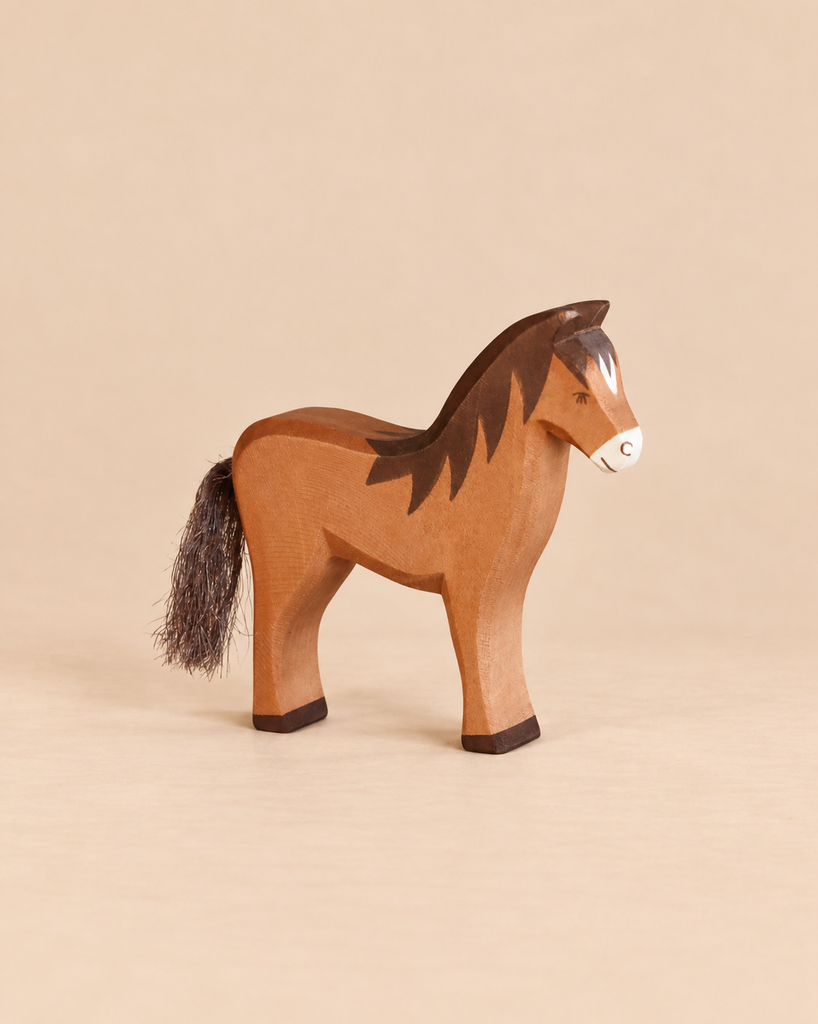An Ostheimer Horse - Brown handcrafted wooden toy with a dark mane and a fibrous tail.