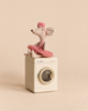A plush mouse wearing a pink tutu and headband sits on a Maileg Washing Machine For Mice as part of a mouse family.