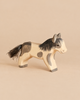 Ostheimer Pony - Running, a hand-carved wooden toy with painted grey patches and a dark brush-style tail, perfect for imaginative play.