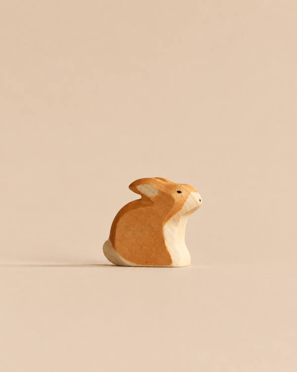 A Handmade Holzwald Rabbit - Sitting figurine, crafted with natural wood grain detail in a small, sitting position.
