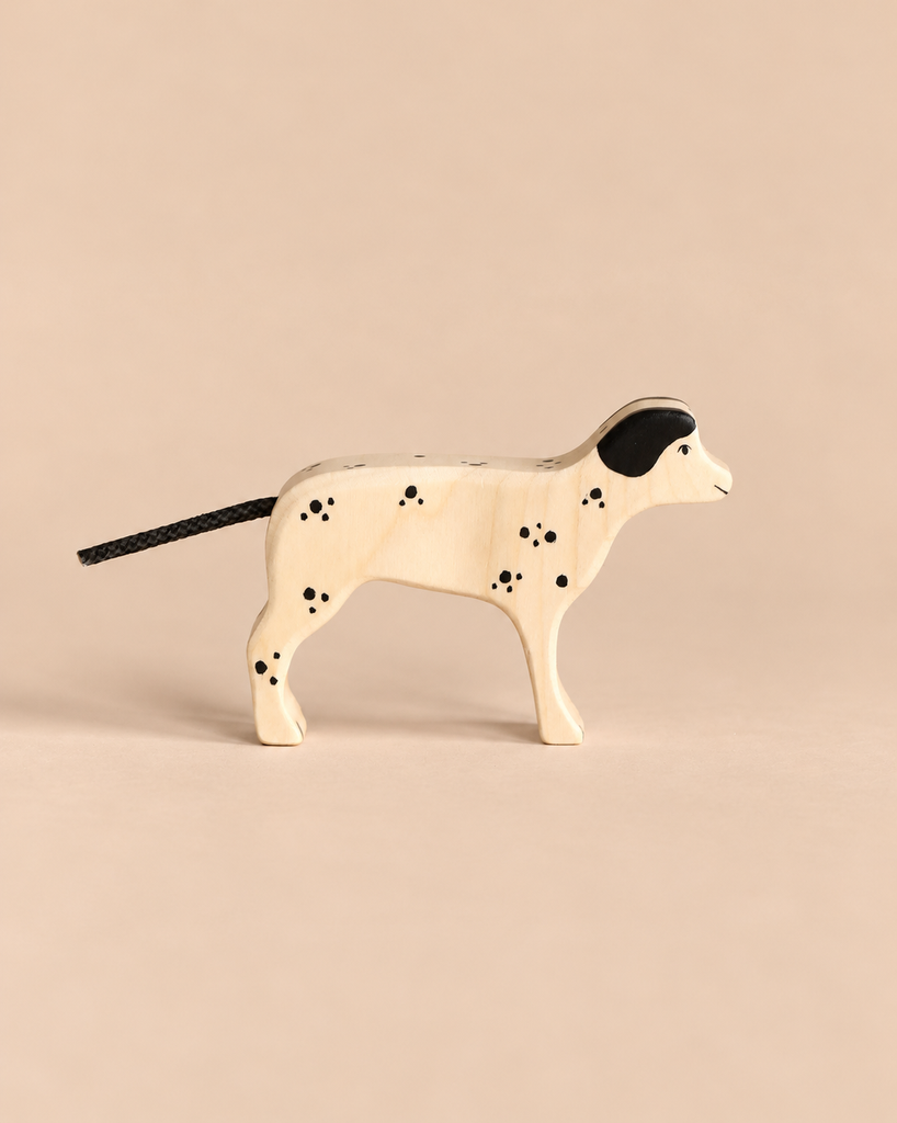 Holztiger Dalmatian Dog handcrafted from wood with painted black spots and a rope tail.