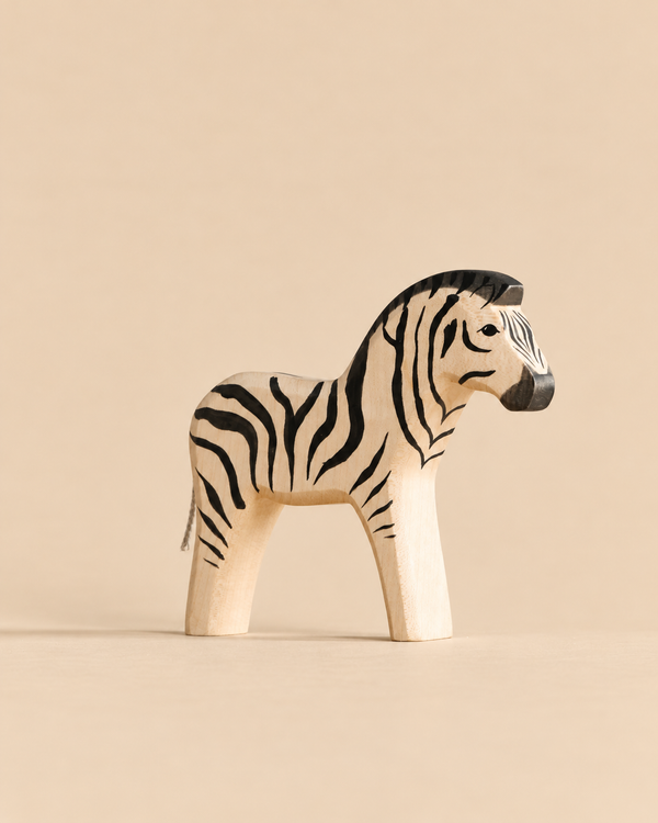 Small Handmade Holzwald Zebra figurine with painted black stripes.