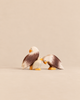 An Ostheimer Bald Eagle Family Set featuring two adult wooden eagle figures standing beside a smaller eagle chick.