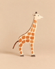 Holztiger Giraffe handcrafted wooden toy with a brown spot pattern and a string tail.