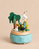 Unicorn Music Box featuring a white unicorn atop a waterfall, with a tree, a blue bird, and two swans on a pond.