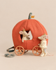 Two royal twin mice wearing small gold crowns from the Maileg Royal Pumpkin Carriage Set, with one sitting inside an orange pumpkin-shaped carriage and one standing beside it.