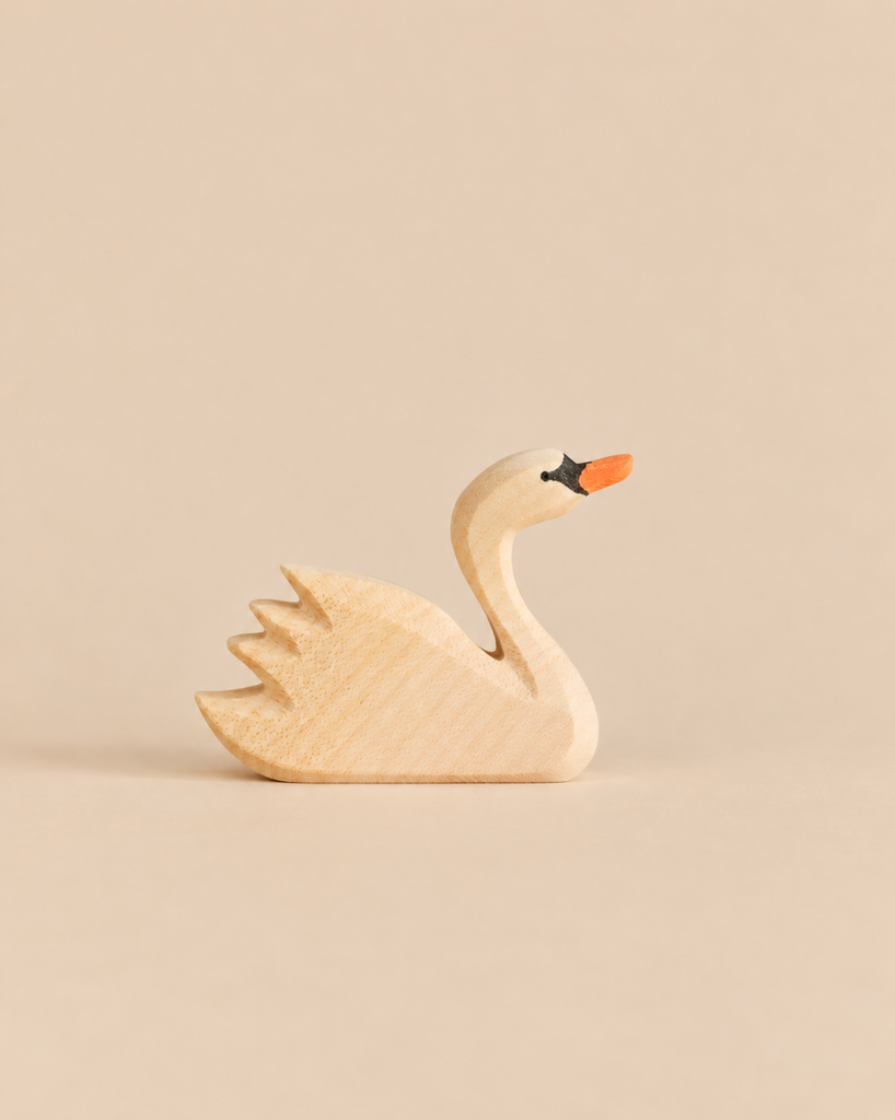 An Ostheimer Swan, Head High, handcrafted from wood with a painted orange beak and black eye detail.