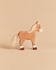 A handcrafted wooden Holztiger Horse Foal, Standing with a light-colored mane and tail, standing on four dark-tipped legs.