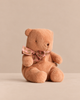 A huggable, tan Maileg Teddy Bear Plush, Small - Vintage Rose wearing a pink and brown plaid bow around its neck.