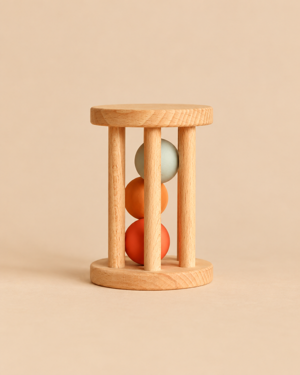 Sabo Concept Rolling Rattle - Lagoon wooden baby rattle featuring vertical dowels enclosing three stacked spheres in blue, orange, and terracotta.