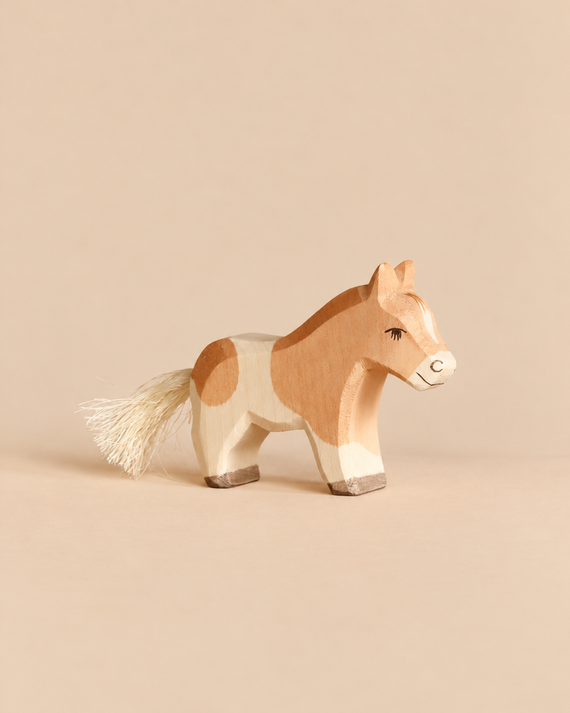 Hand-painted Ostheimer Horse - Shetland Pony Colt figurine, tan and white with a brush tail.
