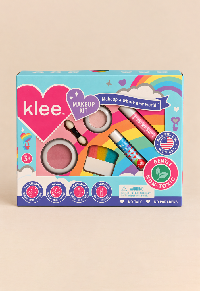 The Klee Naturals Makeup Kit - After the Rain- Rainbow Dream is a rainbow-themed box containing non-toxic mineral makeup, including blush, eyeshadow, a dual-ended applicator, a blush brush, and two lip shimmer tubes.