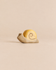 A Handmade Holzwald Snail, a sustainable wooden toy featuring a yellow shell with a painted spiral.