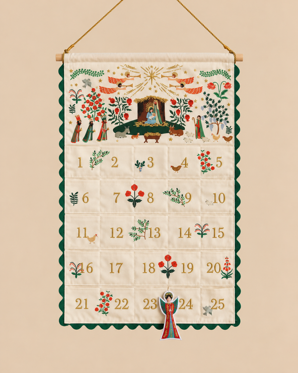 Nativity Embroidered Hanging Advent Calendar with numbered pockets from 1 to 25, decorated with embroidered scenes, angels, and botanical motifs, featuring a hanging angel ornament on a string.