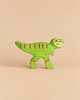 Handcrafted green Holztiger Tyrannosaurus Rex dinosaur toy with red stripe markings.